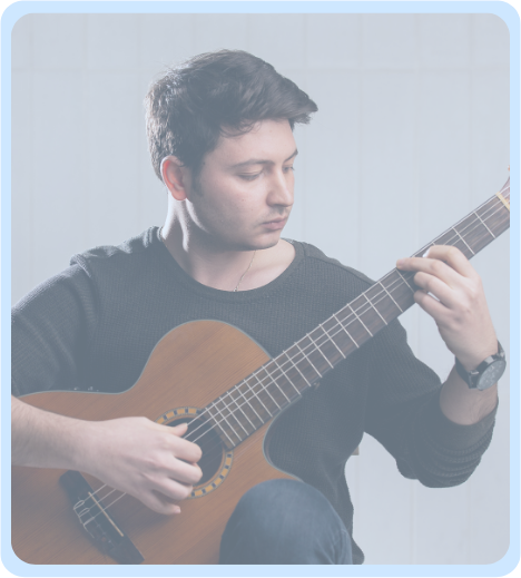A volunteer musician playing an acoustic guitar